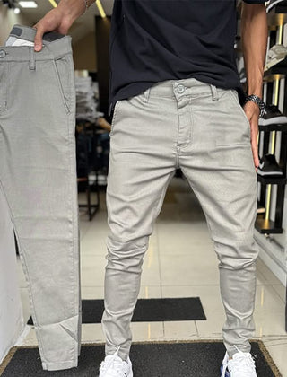 Light grey slim trousers with tapered legs, button waist, and side pockets