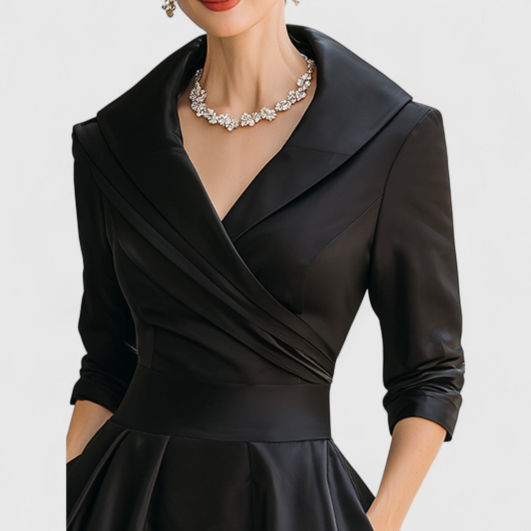 Black midi dress with surplice V-neck, three-quarter sleeves, and pleated waist detail