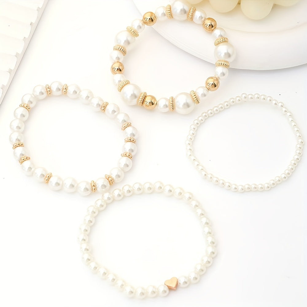 Pearl heart bracelet set laid flat with white pearl strands and gold bead accents