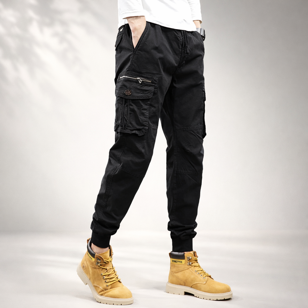 Black cargo pants on model with drawstring waist, cuffed ankles, and side cargo pockets