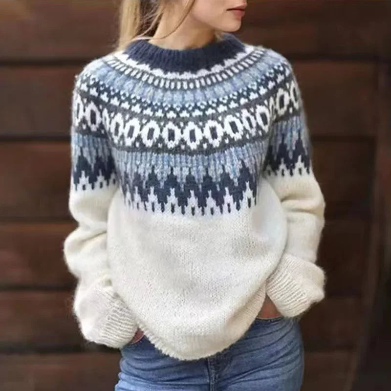 Cream knit sweater with navy patterned yoke, long sleeves, and ribbed cuffs