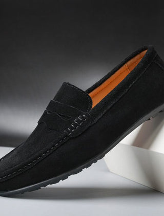 Black suede slip-on loafers with stitched penny strap and moc toe
