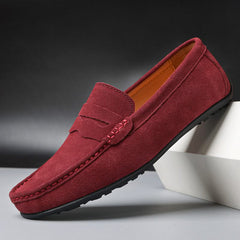 Suede loafers in maroon with slip-on design, strap detailing, and rubber sole