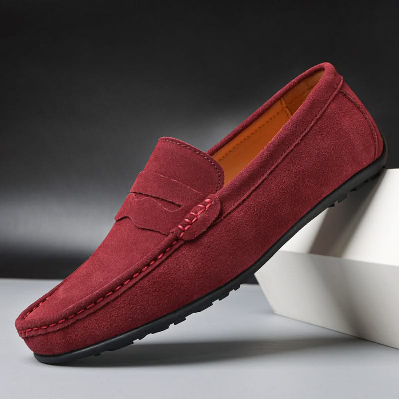 Suede loafers in maroon with slip-on design, strap detailing, and rubber sole