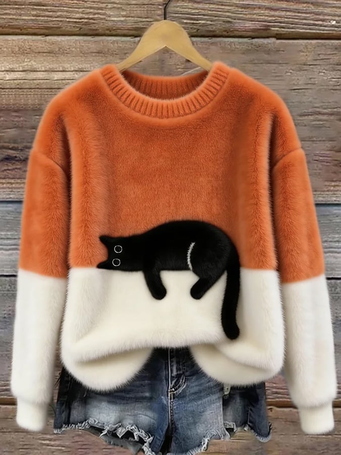 Orange oversized sweater with white hem and cuffs, featuring a black penguin front graphic.