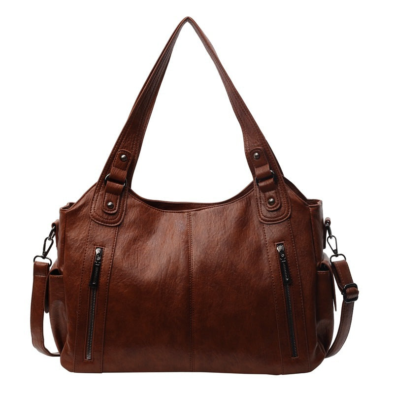 RAE Classic leather handbag, brown with two top handles, zip details, and shoulder strap