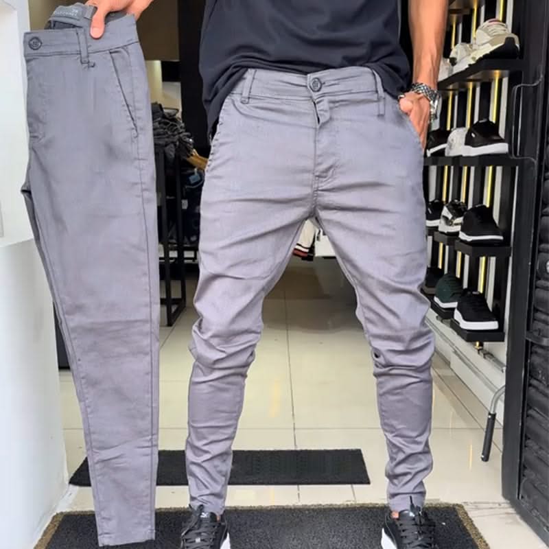 Grey slim trousers with tapered legs, button waist, and side pockets