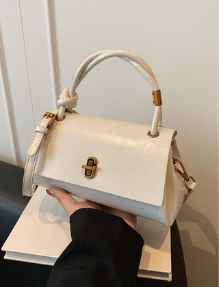White leather-look crossbody shoulder bag with gold-tone clasp and top flap