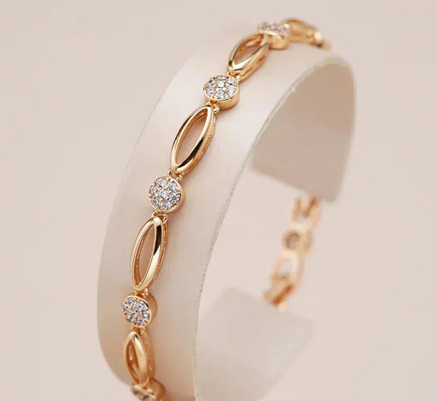Gold-tone zirconia accent bracelet with oval links and round crystal stones.