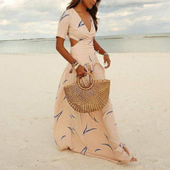 Apricot V-neck maxi dress with short sleeves, blue abstract print, and flowing skirt