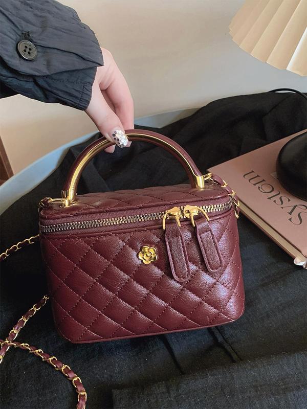 Burgundy quilted crossbody bag with gold-tone chain strap and top zip closure