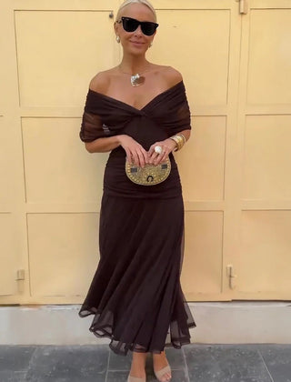 Brown off-shoulder maxi dress with draped neckline and sheer ruffle skirt
