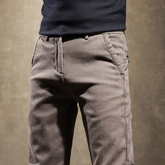 Khaki slim-fit pants close-up of waistband and side pocket