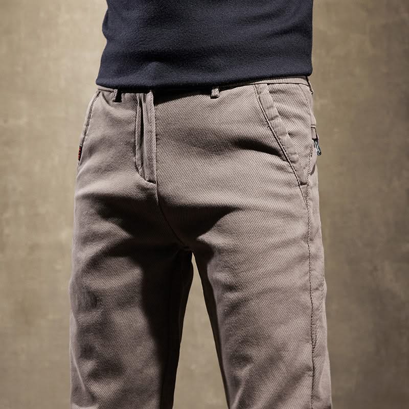 Khaki slim-fit pants close-up of waistband and side pocket