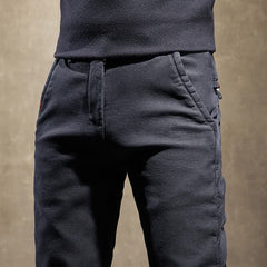 Black slim-fit pants close-up of waistband and side pockets
