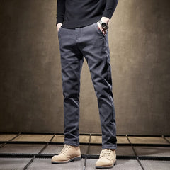 Dark gray slim-fit pants front view with tapered legs