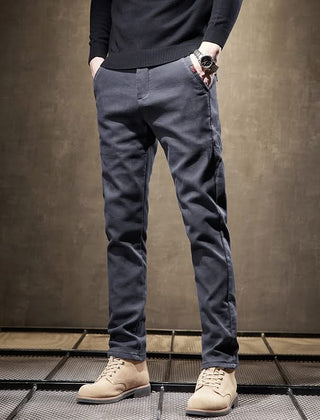 Dark gray slim-fit pants front view with tapered legs