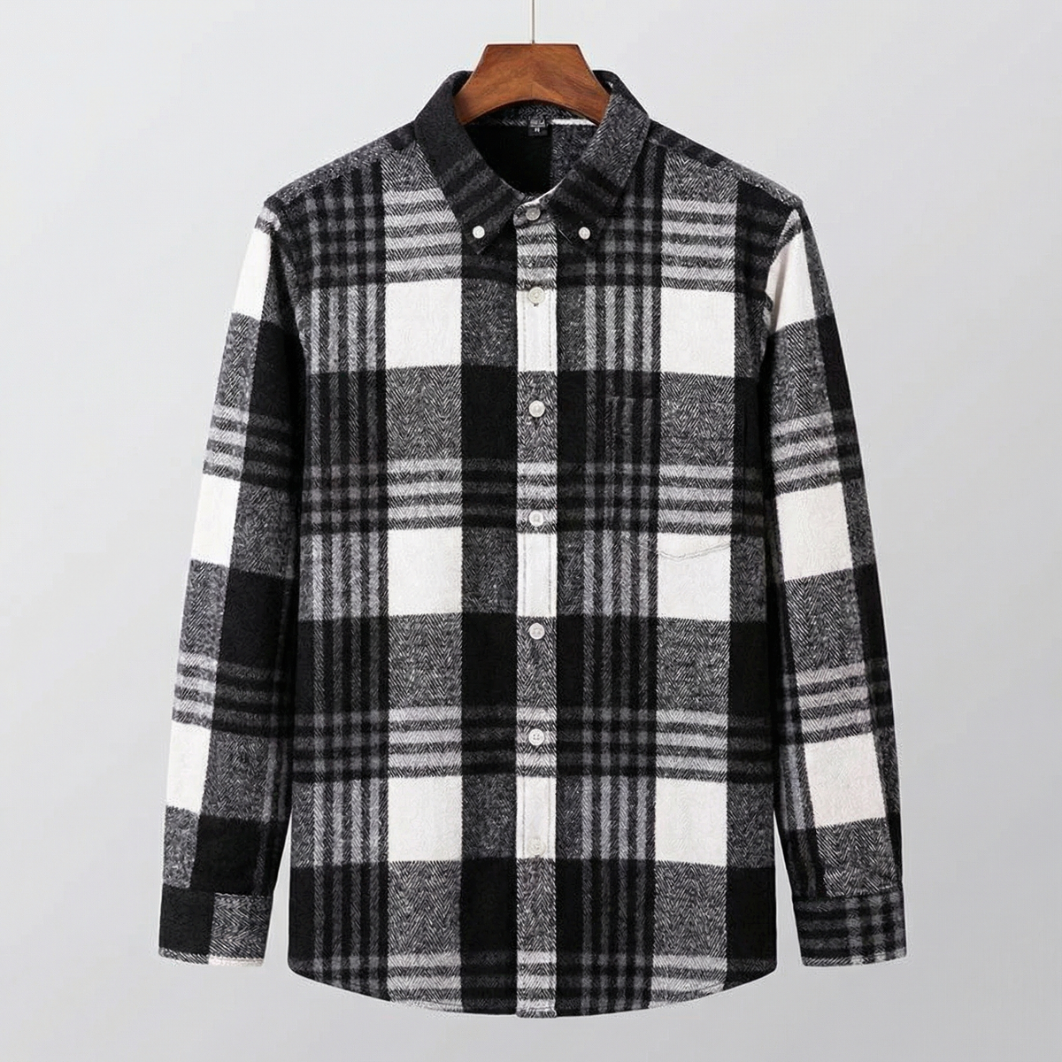 Cotton flannel plaid button-up shirt on hanger, black, gray, and white checks.