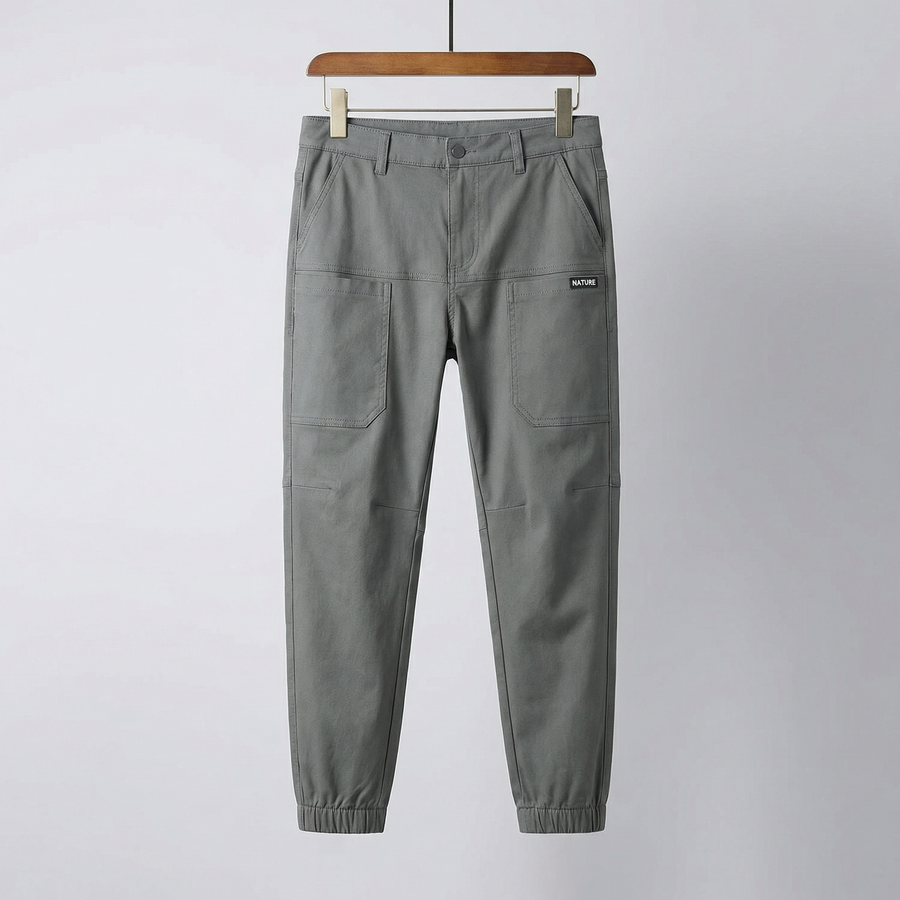 Grey stretch utility pants with drawstring waist, button fly, and cargo pockets