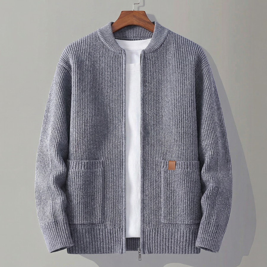 Grey rib knit zip-up jacket with stand collar, front pockets, and tan logo patch