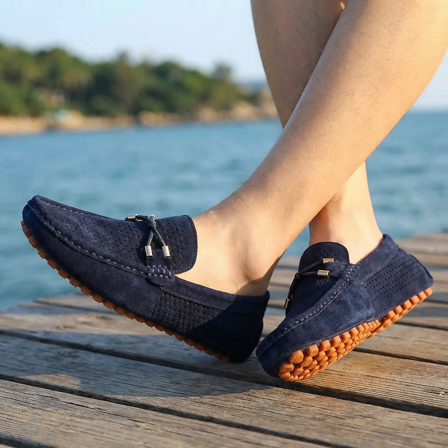 Navy perforated leather loafer slip-on with metal bar detail and rubber tread sole
