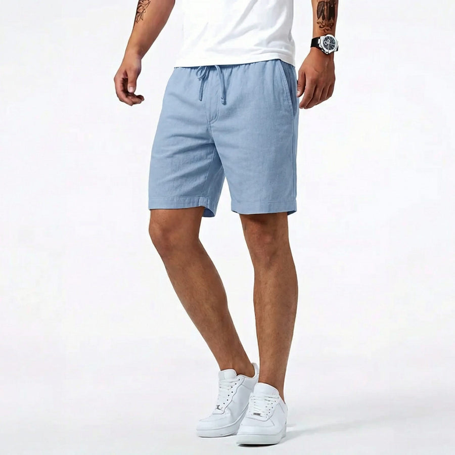Blue summer shorts with drawstring waistband and side pockets, worn with sneakers