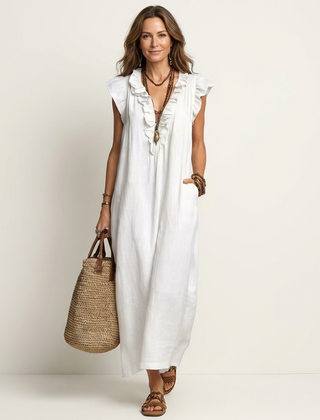 White linen maxi dress with ruffled V-neck and short cap sleeves.