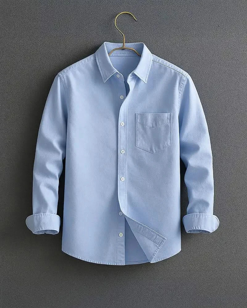 Light blue long-sleeve button-up shirt with chest pocket and diagonal front panel.
