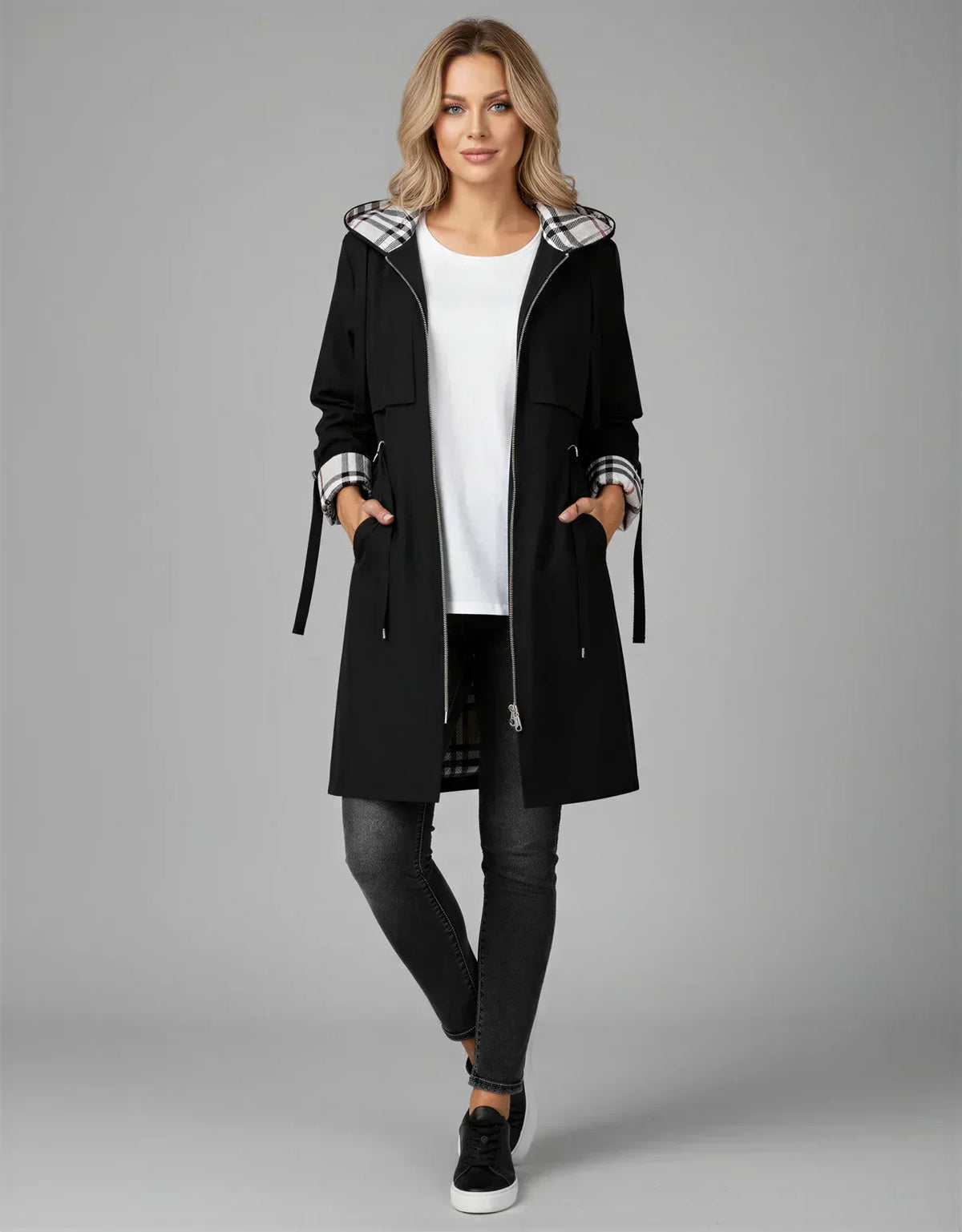 Women's black hooded waterproof jacket with plaid inner hood and side ties