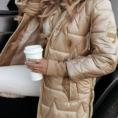 Leviana™ long quilted jacket in beige with hood and full front zip, sleeve logo patch