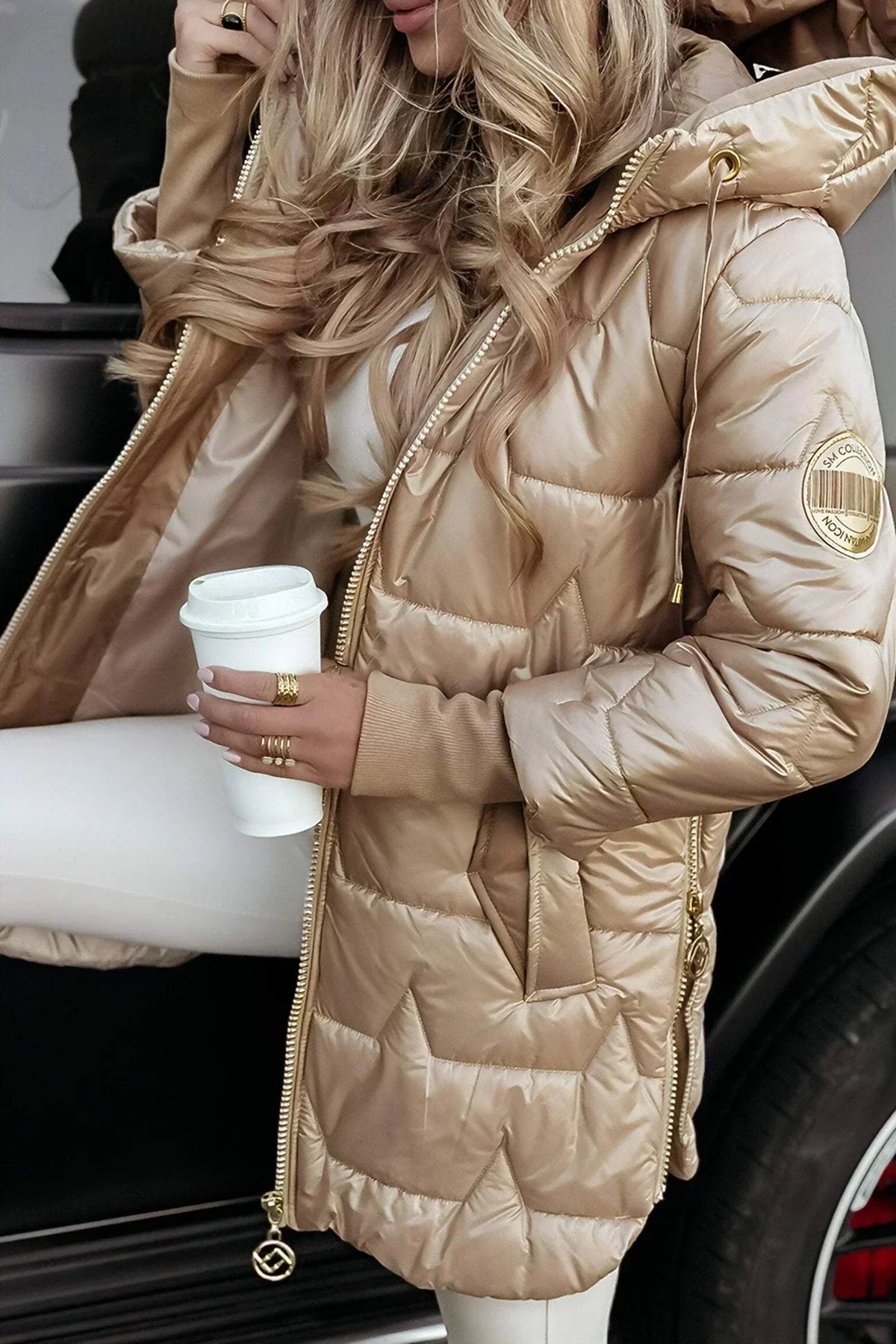 Leviana™ long quilted jacket in beige with hood and full front zip, sleeve logo patch