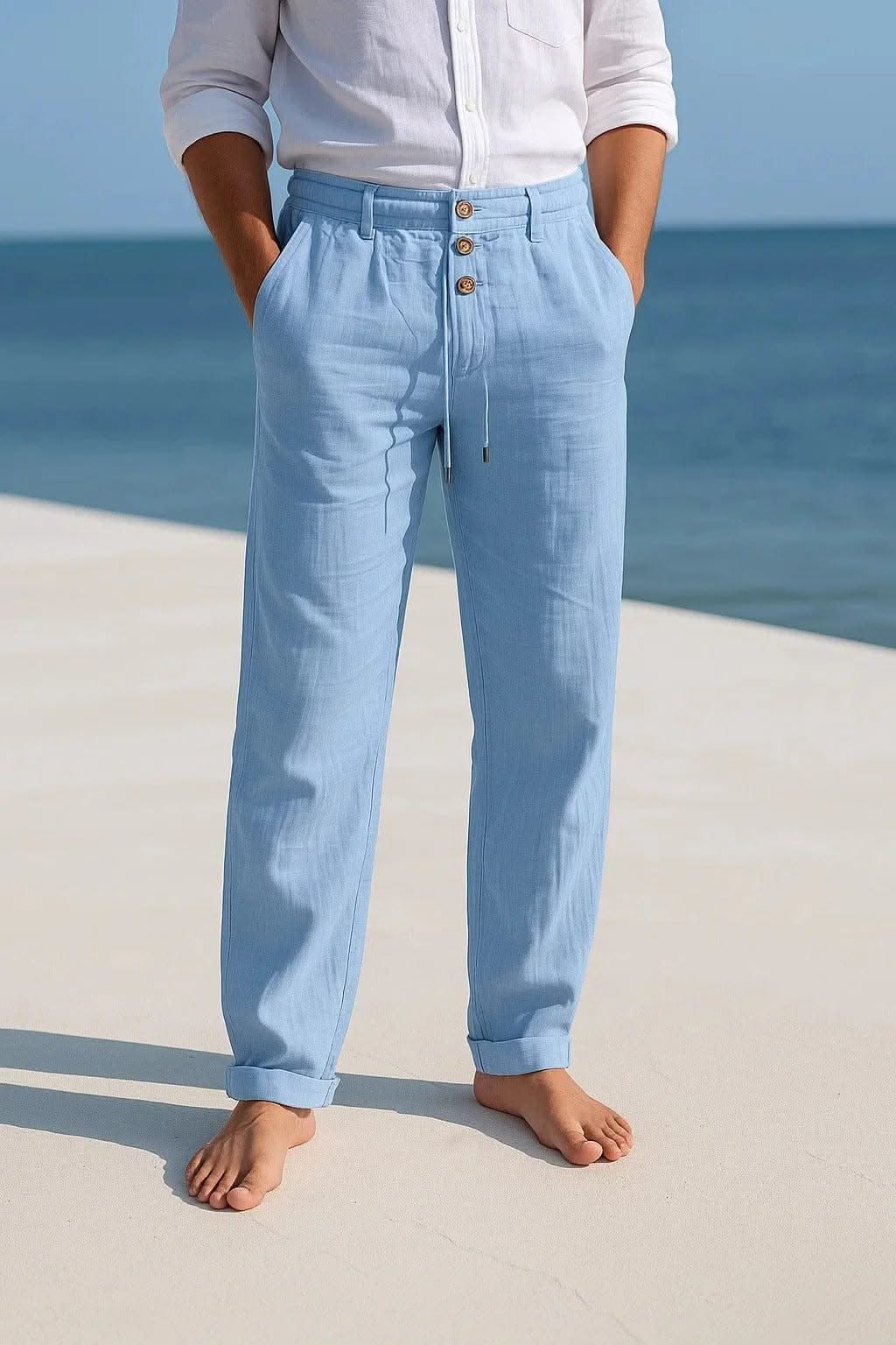 Light blue linen trousers with button front and drawstring waist, relaxed straight legs