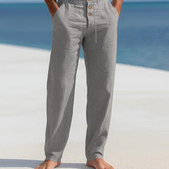 Grey linen trousers with button front and drawstring waist, relaxed straight legs