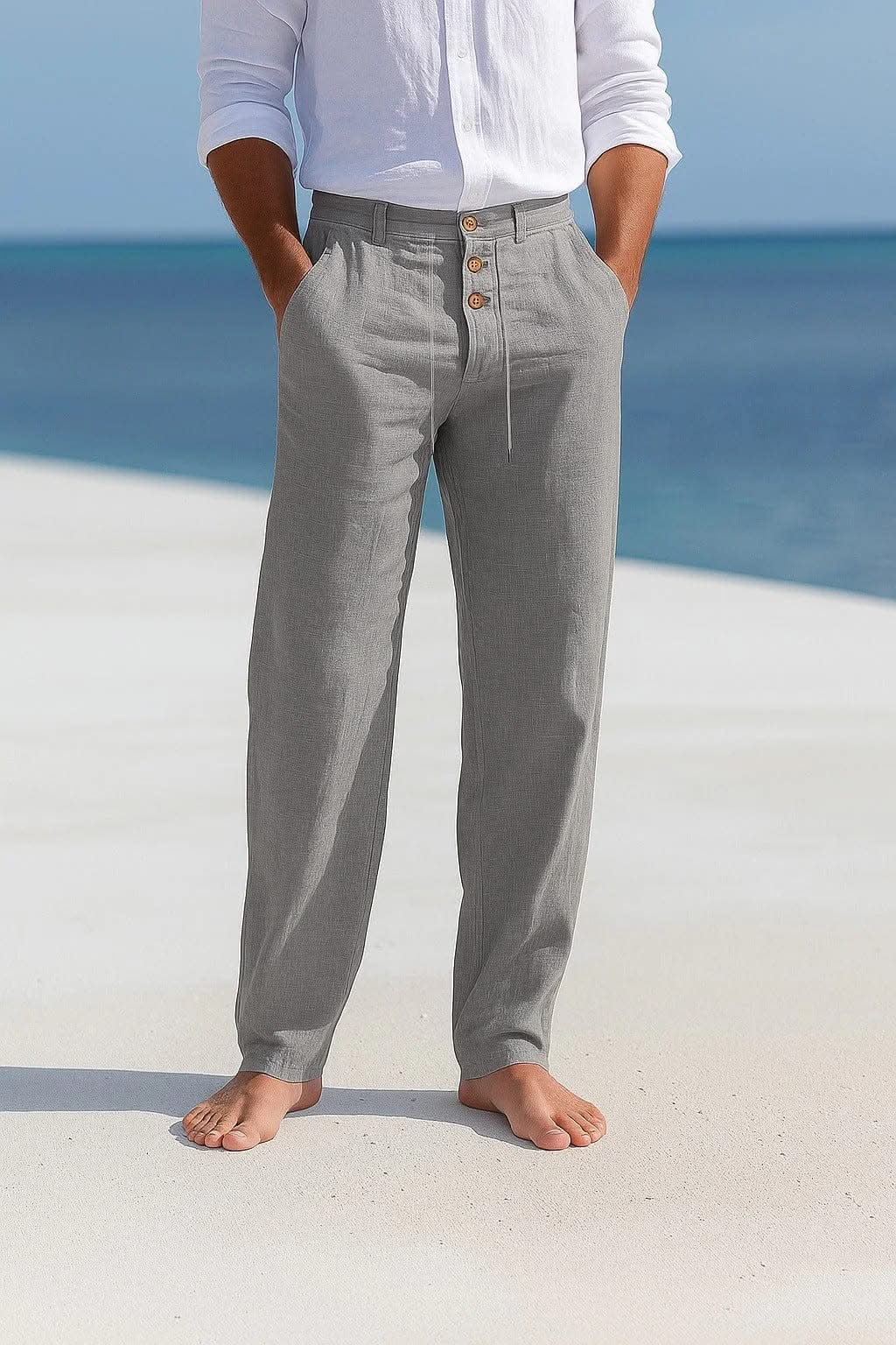 Grey linen trousers with button front and drawstring waist, relaxed straight legs