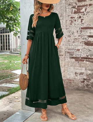 Green midi dress with round neck, gathered waist, 3/4 sleeves with sheer stripe hem.