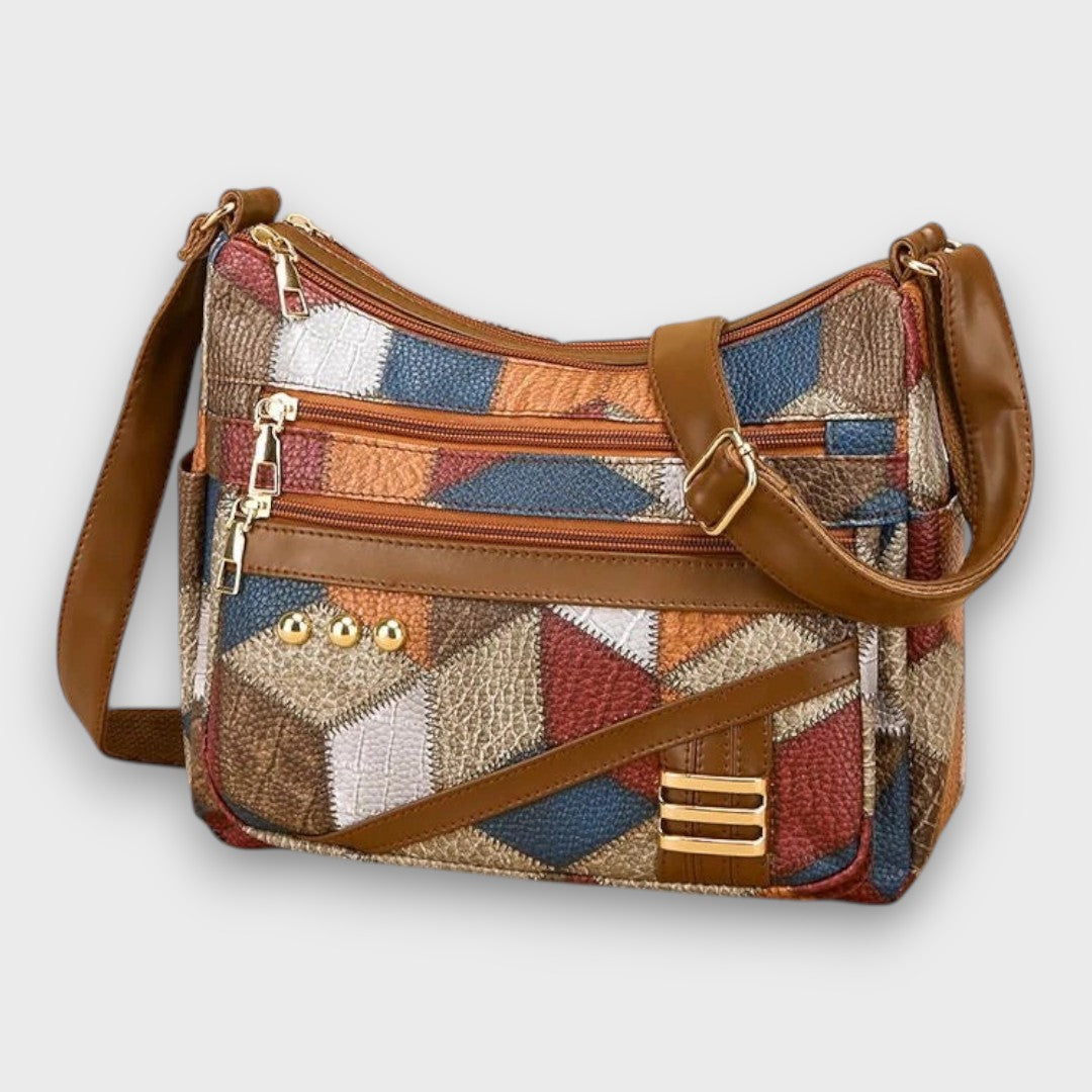 Patchwork leather shoulder bag with front zip pocket and adjustable leather strap