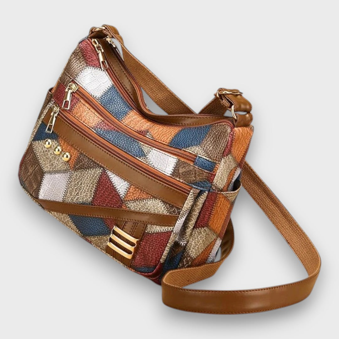Patchwork leather shoulder bag with angled side zip and adjustable brown leather strap