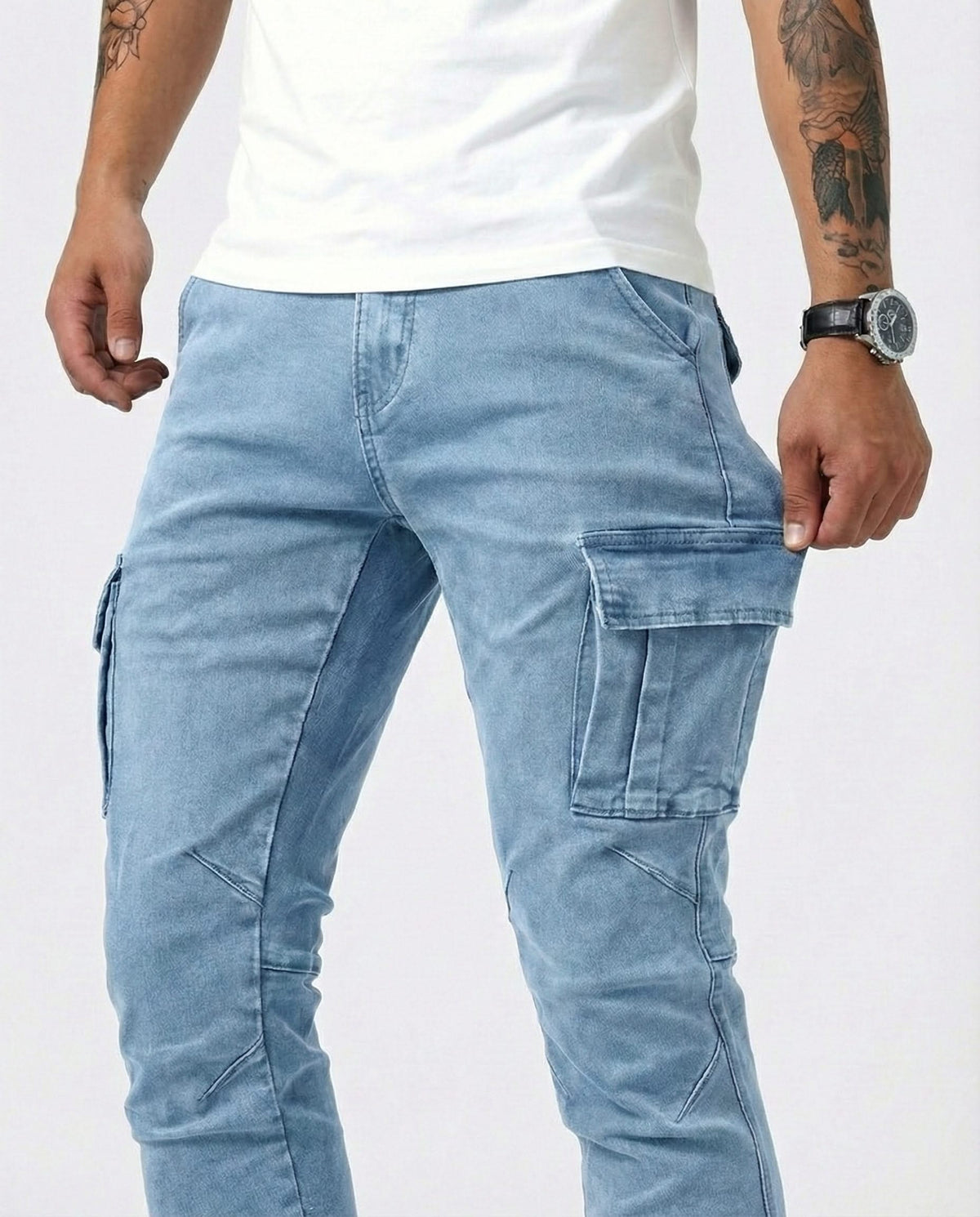 Men's light blue cargo trousers showing front cargo pockets and stitched panels