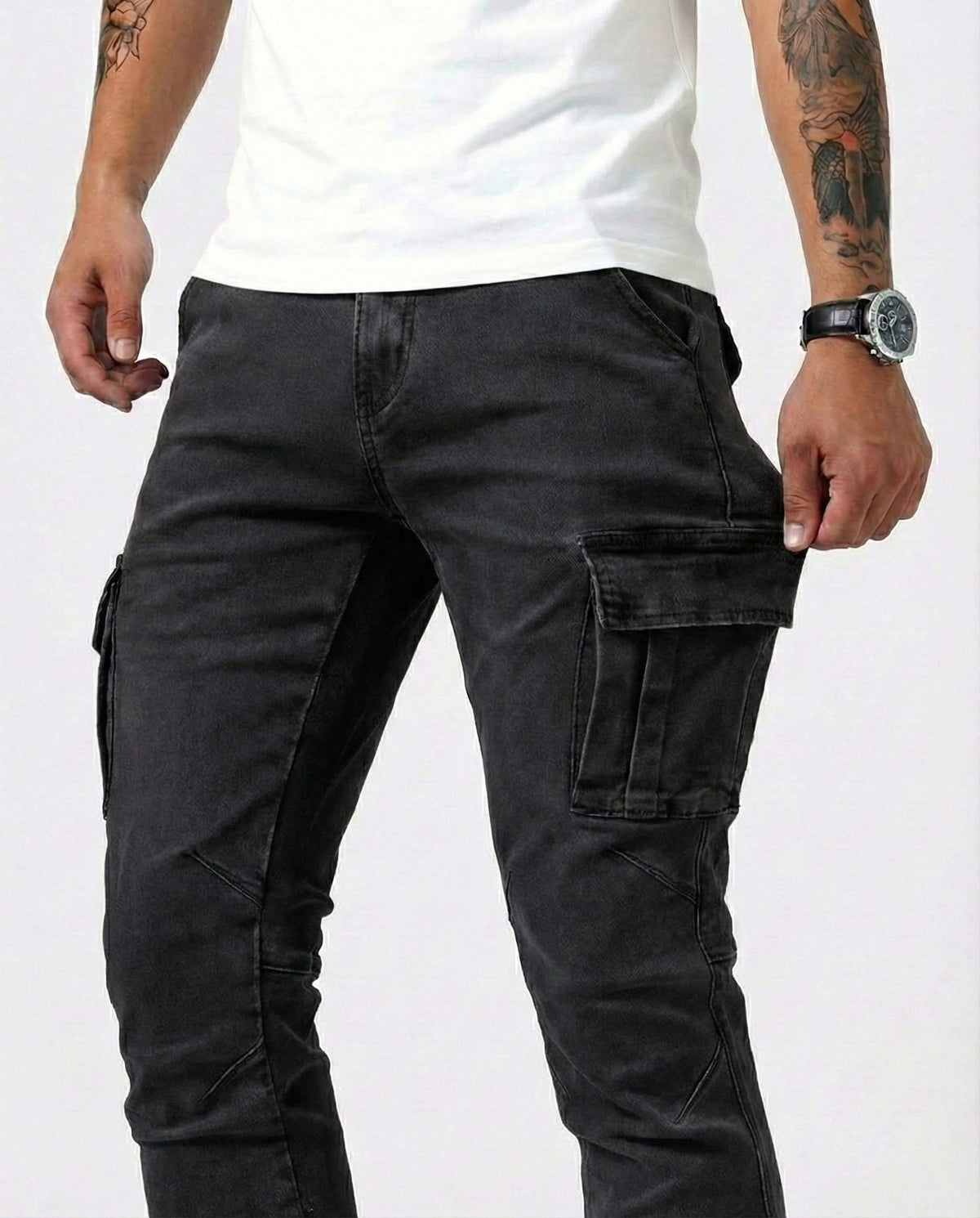 Black cargo trousers with flap cargo pockets on the thighs, slim fit
