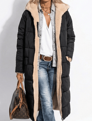 Black long quilted coat with tan sherpa collar and zip front