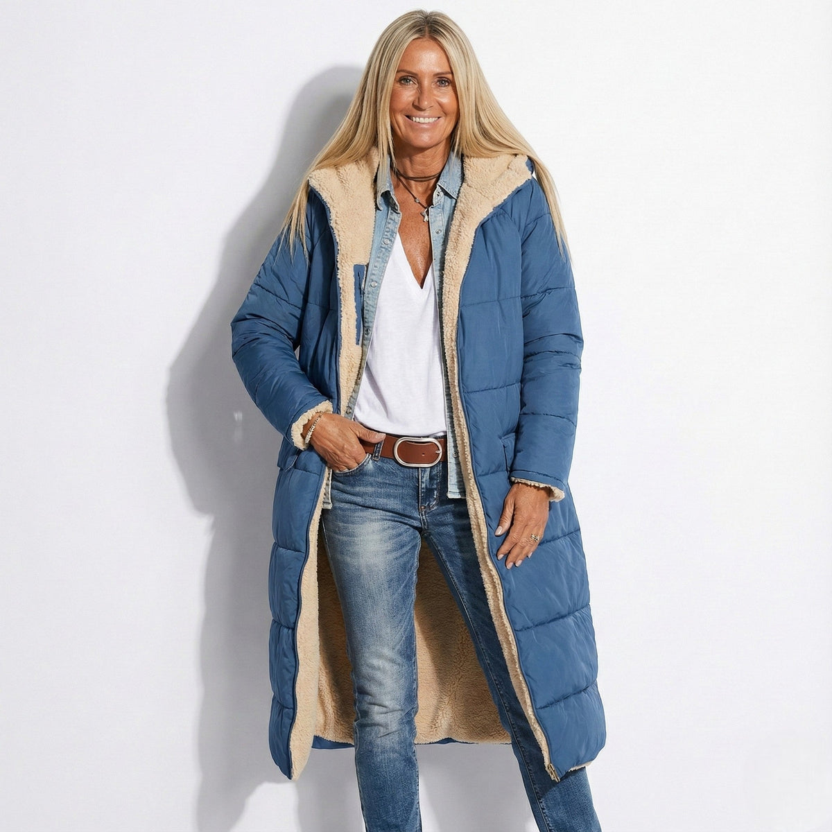 Navy long quilted coat with tan sherpa-lined collar and zip front