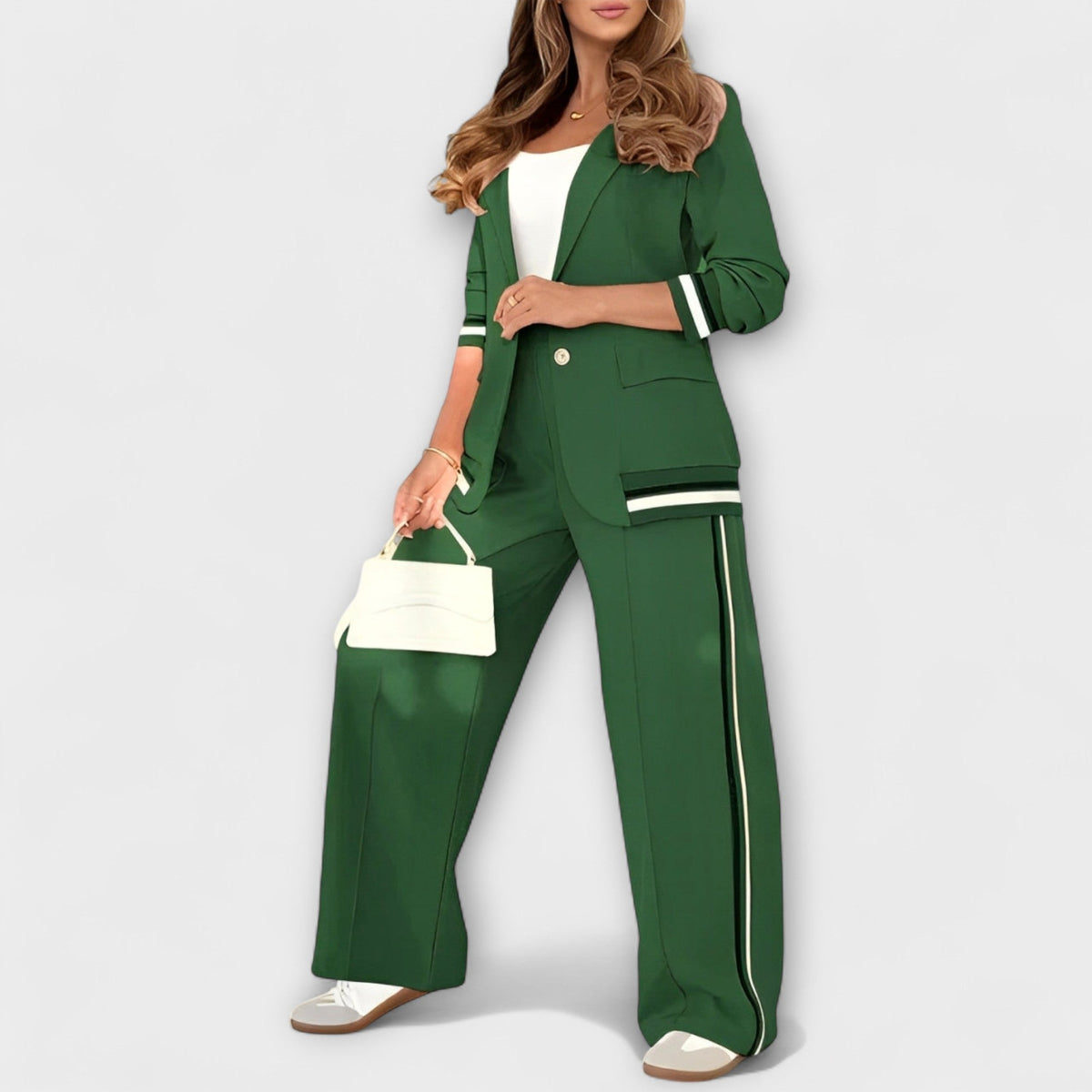 Green two-piece blazer and wide-leg trousers with gold button and contrast side stripe.
