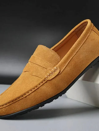 Tan suede slip-on loafers with stitched penny strap and moc toe