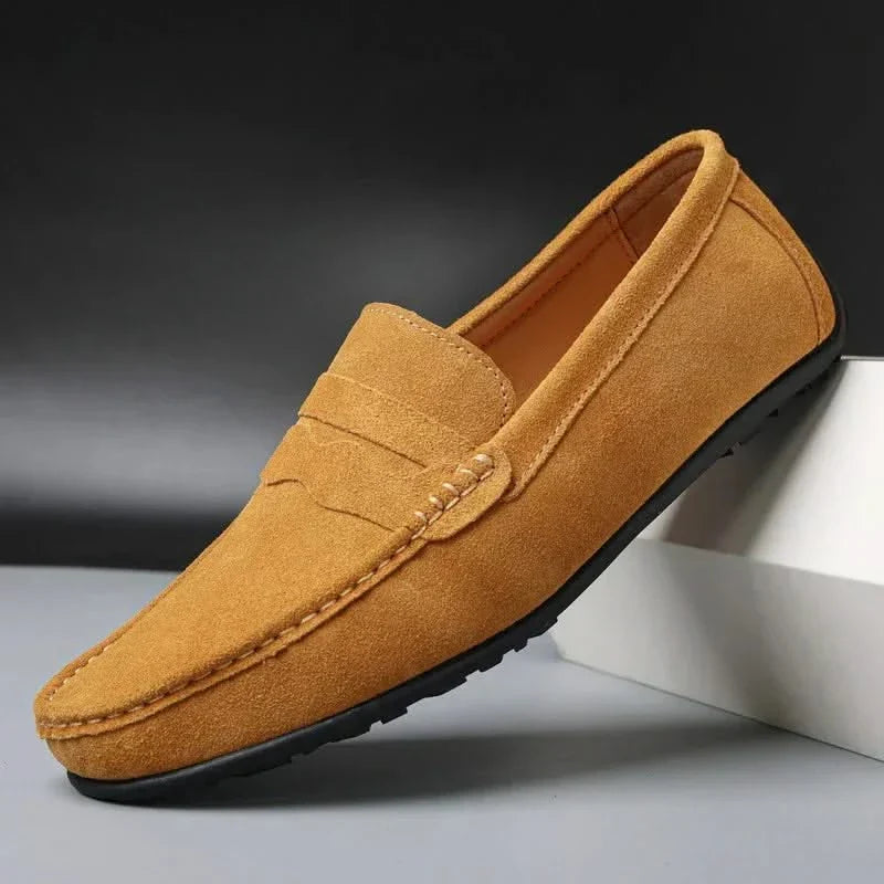 Tan suede slip-on loafers with stitched penny strap and moc toe