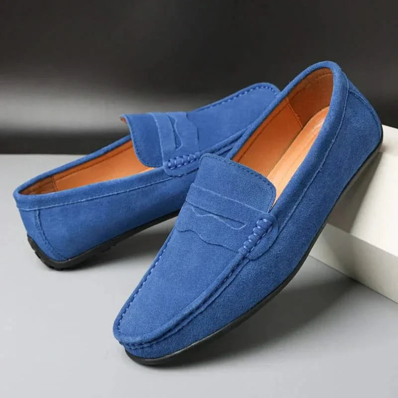 Blue suede slip-on loafers with stitched penny strap and moc toe