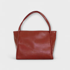 Red leather-look tote bag with wide top handles and smooth rectangular front