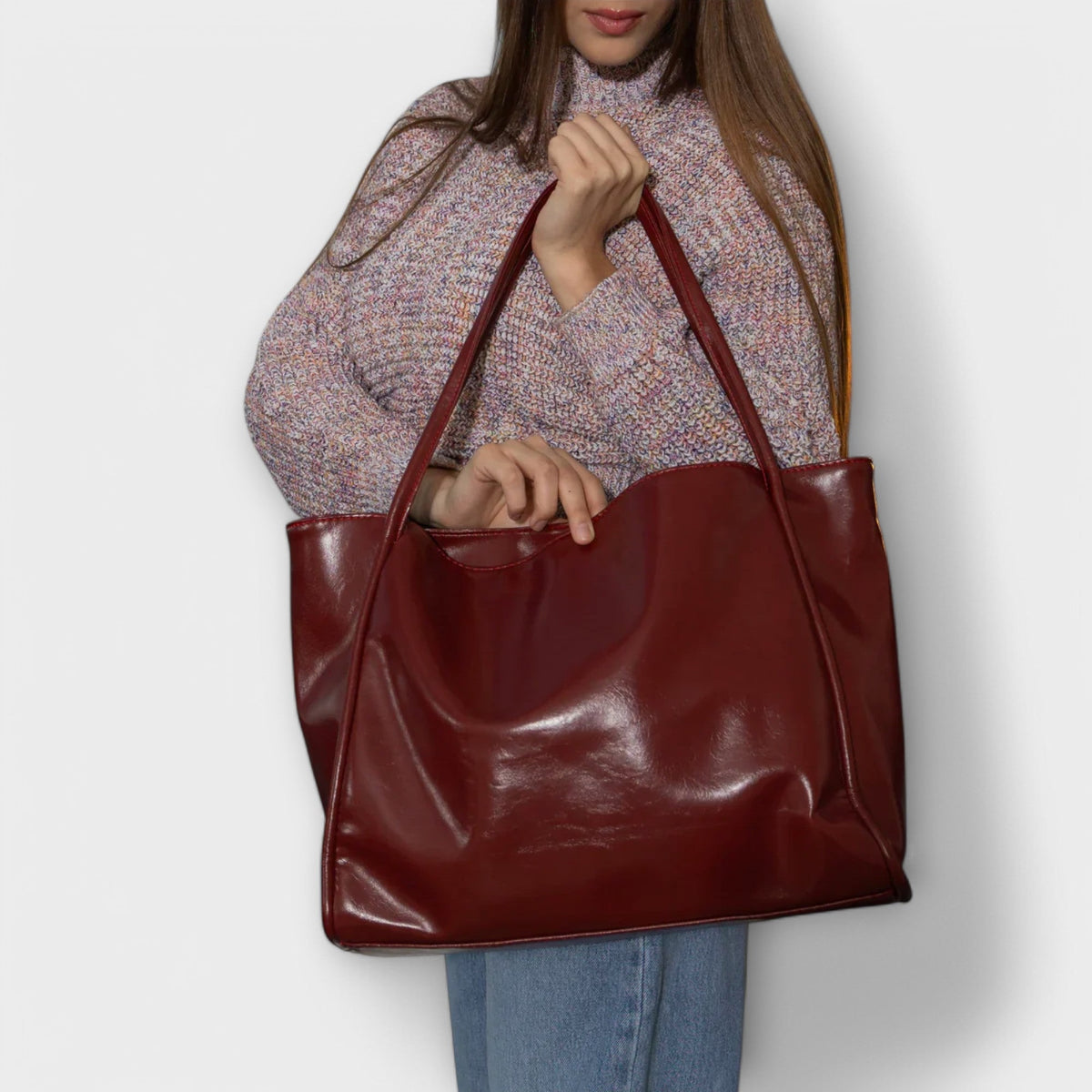 Red-burgundy glossy tote bag with two top handles and open top
