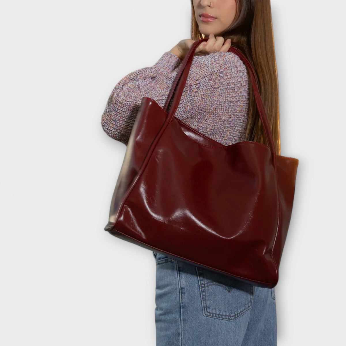 Burgundy glossy tote bag with wide opening and shoulder-length handles