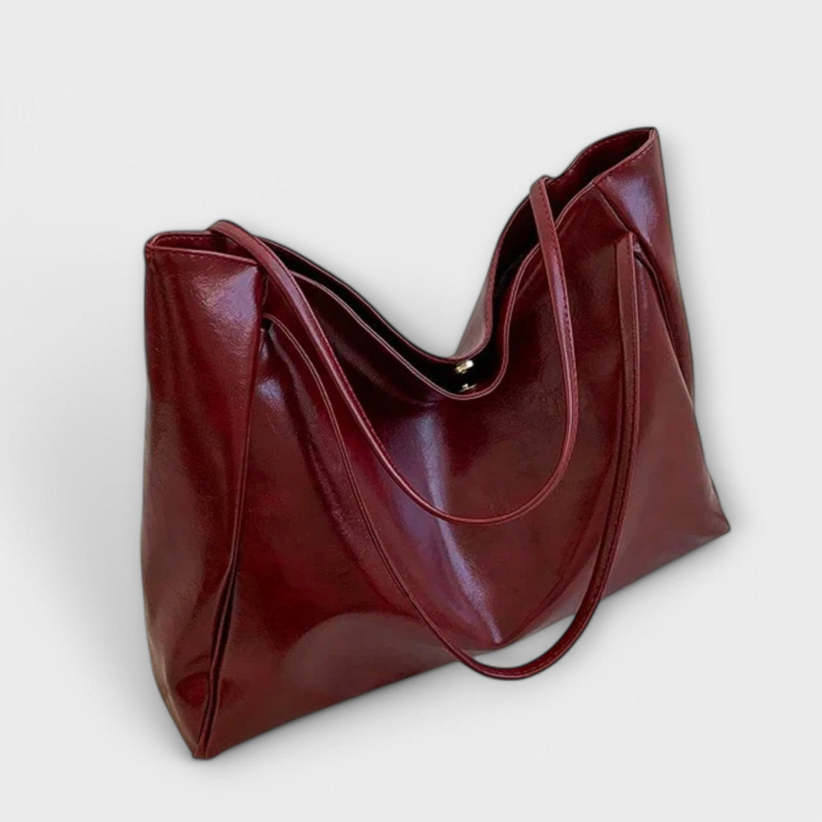 Burgundy leather-look tote bag, side view with double top handles