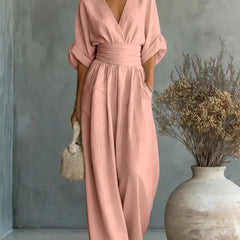 Blush pink V-neck high-waisted jumpsuit with draped sleeves and wide-leg fit